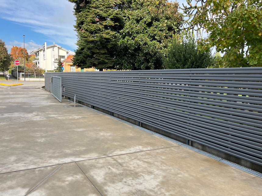 Installazione perimetrale lunga con steccato orizzontale per giardino esterno con doghe in acciaio zincato colore grigio grafite, progetto completato