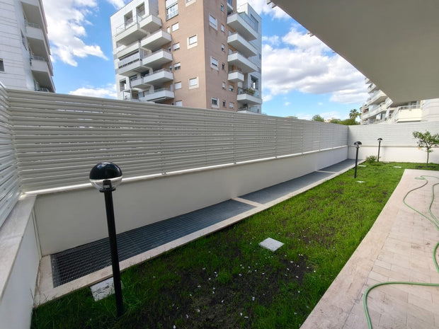 installazione dentro cortile di doghe bianche su muretto