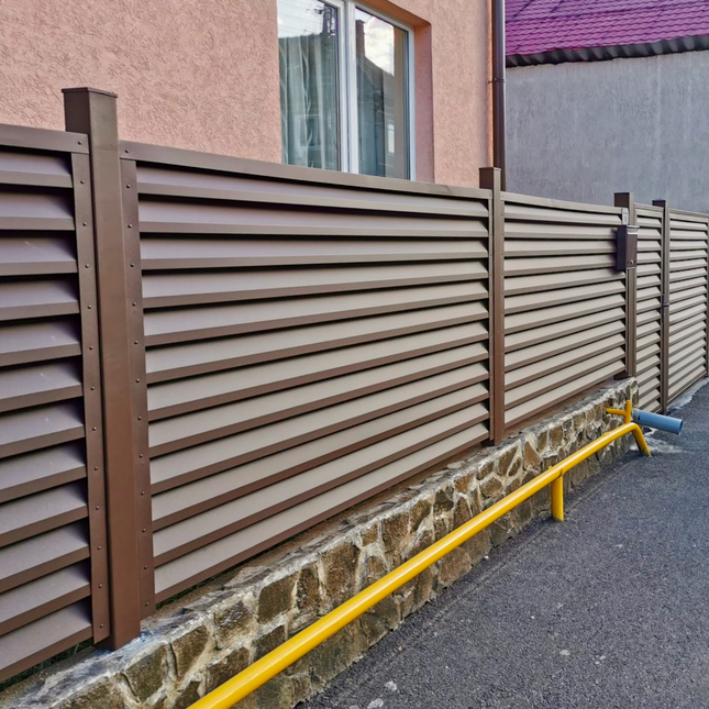 installazione frangivista in acciaio zincato effetto cioccolato colore marrone su piloni inclusi ancorati a un muretto esistente